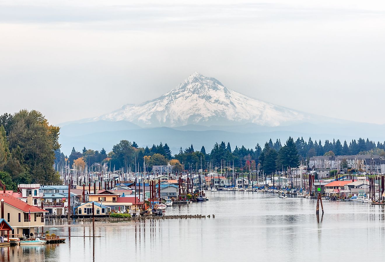 View of Mt. Hood and Portland Marina floating boat houses in Oregon. Image credit Paula Cobleigh via Shutterstock.