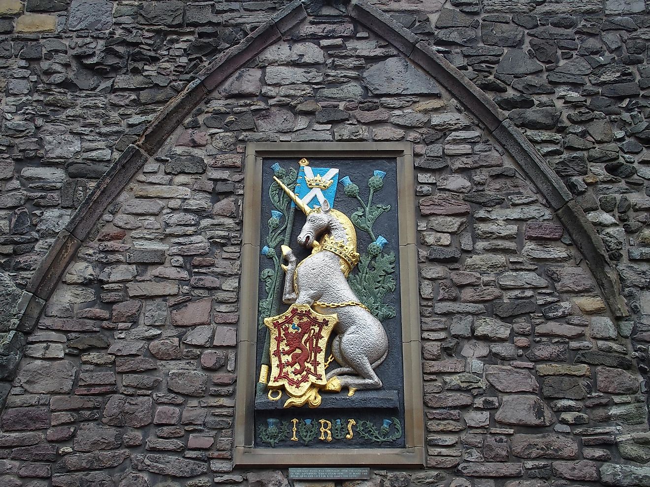 Unicorn of Scotland and red lion rampant on the medieval scottish stone wall