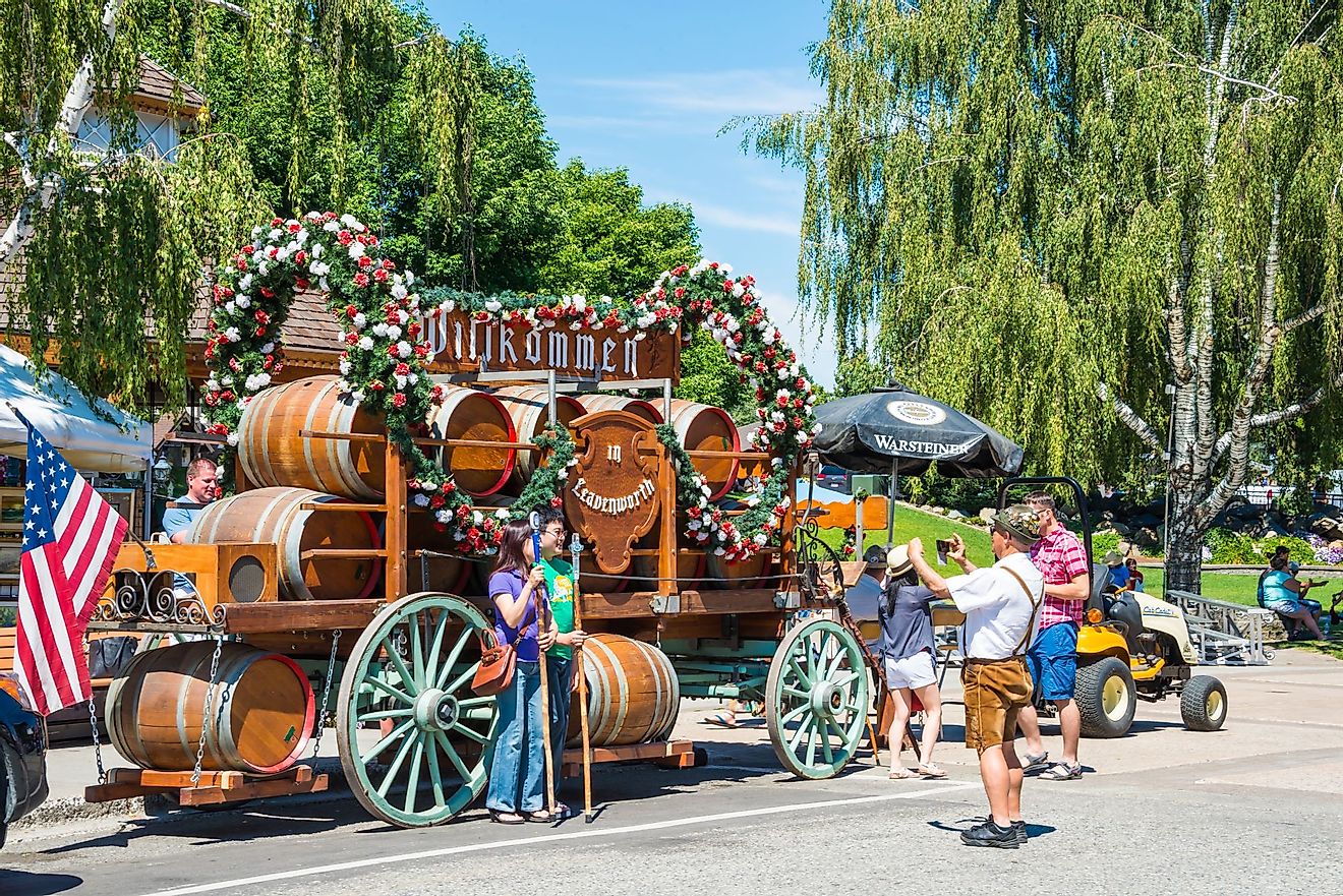 Tourists have a souvenir photo taken in front of a beer wagon float in Leavenworth, Washington. Editorial credit: Denise Lett / Shutterstock.com