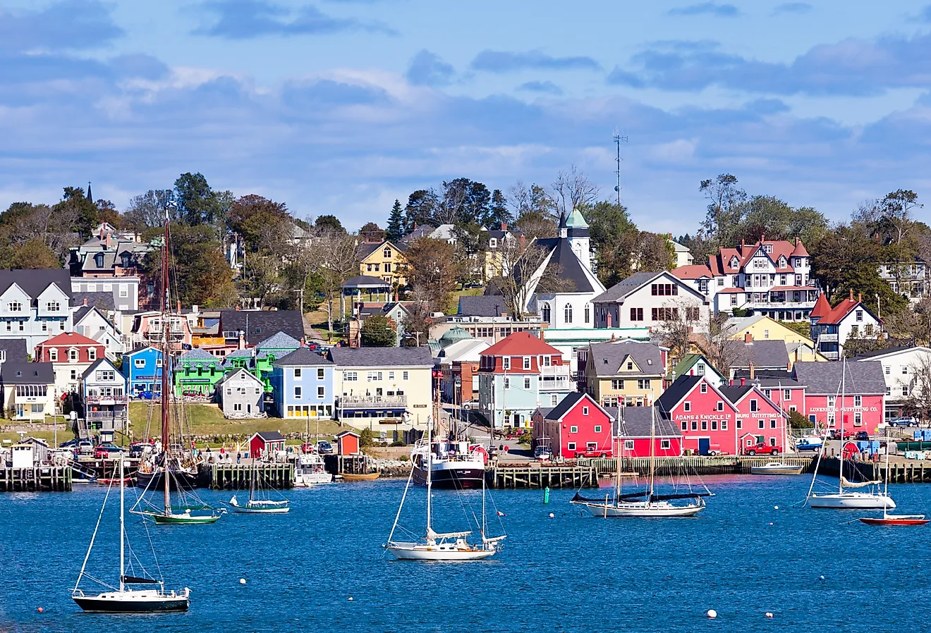 Lunenburg Harbour, Nova Scotia, with colorful red buildings and boats.