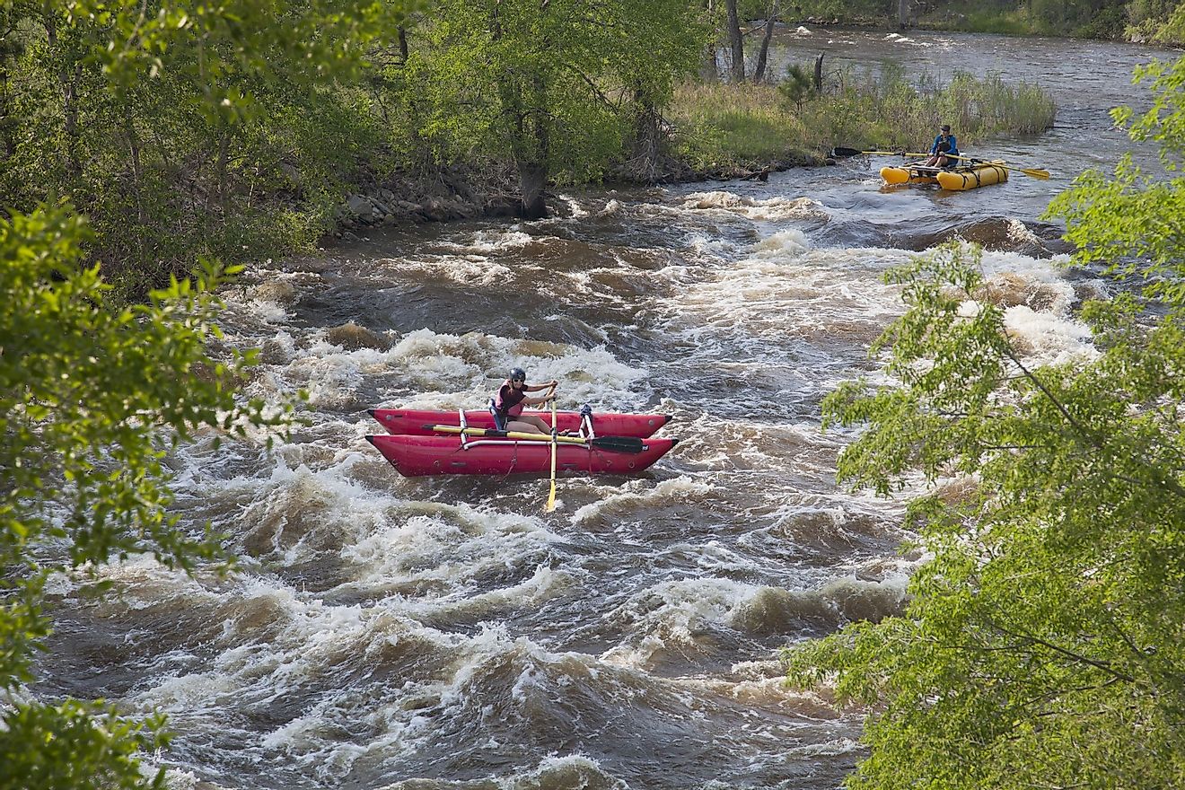 Whitewater rafters enjoy floating over the Mad Dog Rapid on Cache La Poudre River, west of Fort Collins. Editorial credit: marekuliasz / Shutterstock.com