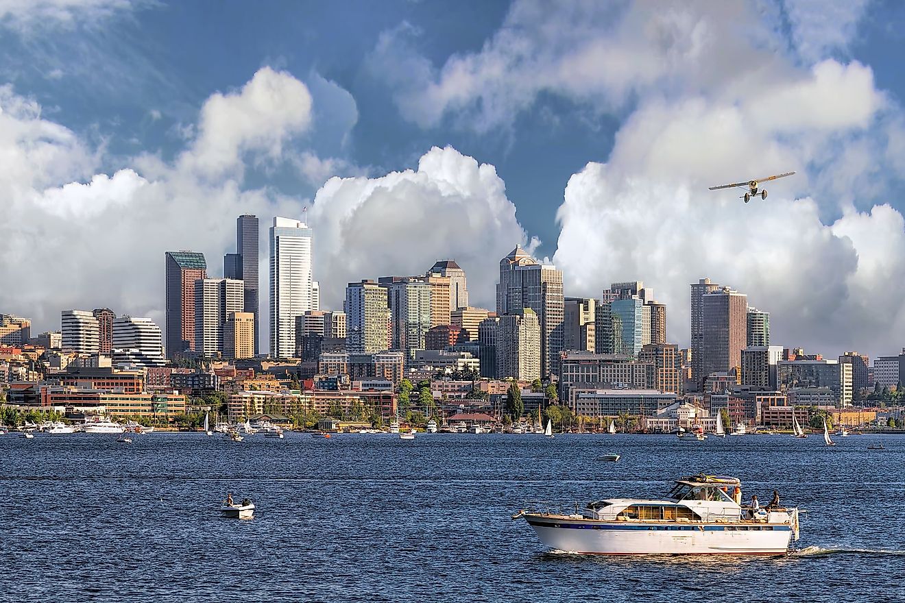 Seattle, Washington, city skyline from Lake Union with white clouds and blue sky. 