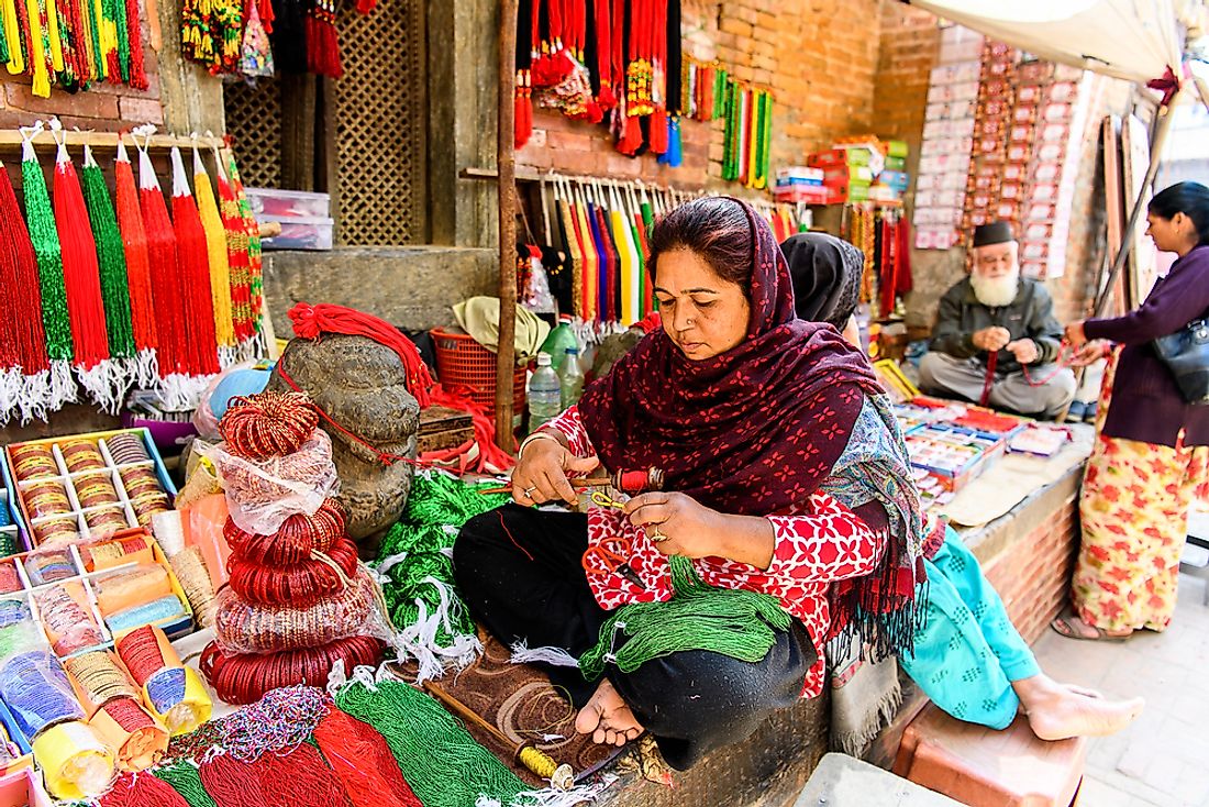 A Chhetri woman working in a market in Katmandu, Nepal. Editorial credit: Anton_Ivanov / Shutterstock.com.