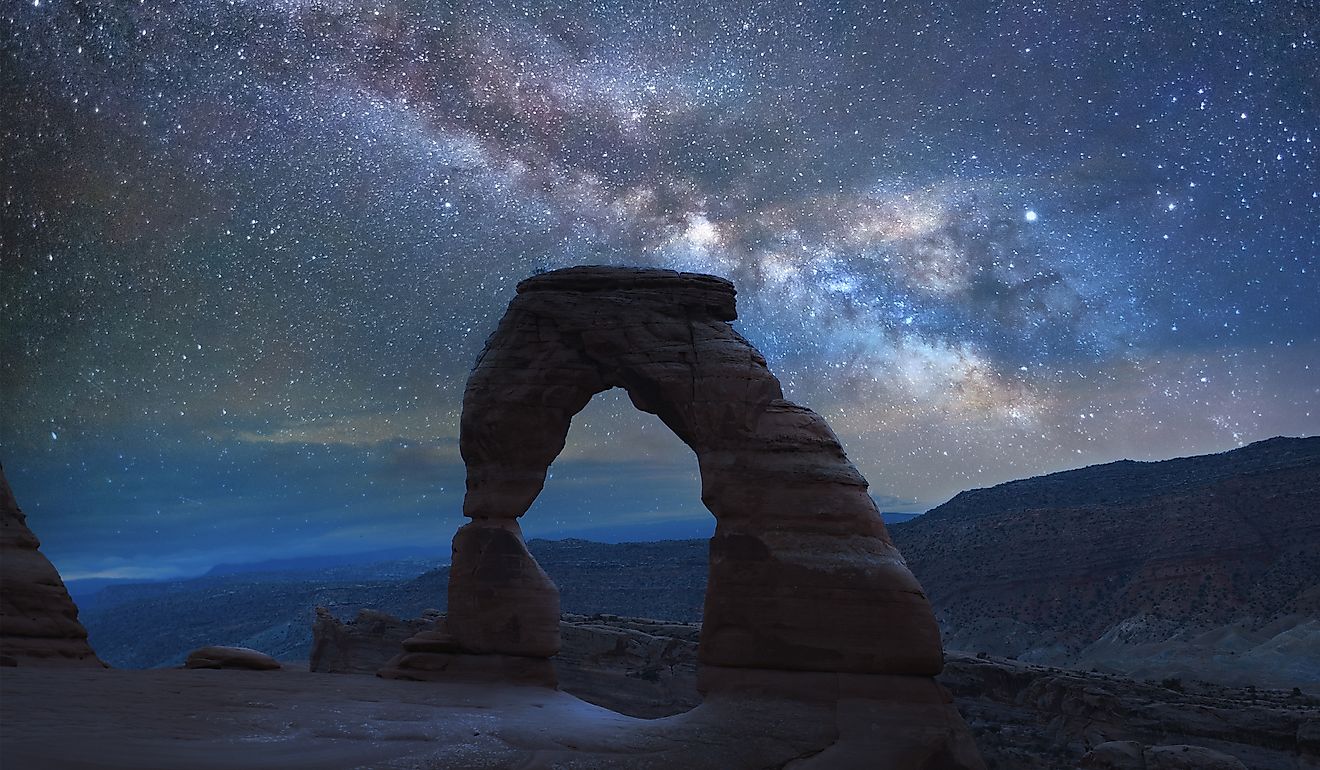 Delicate Arch in Arches National Park under a Milky Way galaxy.