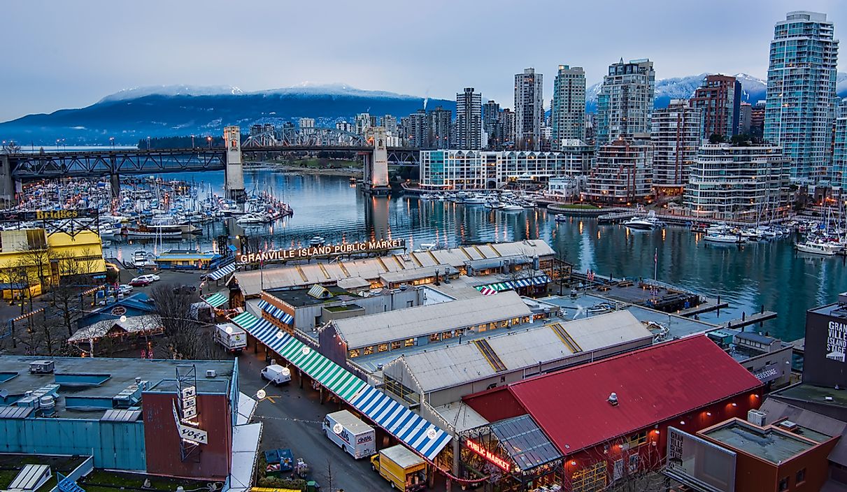 The booths of Granville Island with Vancouver in the background. 