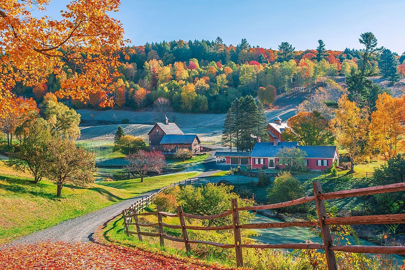 Early autumn foliage scene of houses in the Vermont mountains, Woodstock, Vermont.