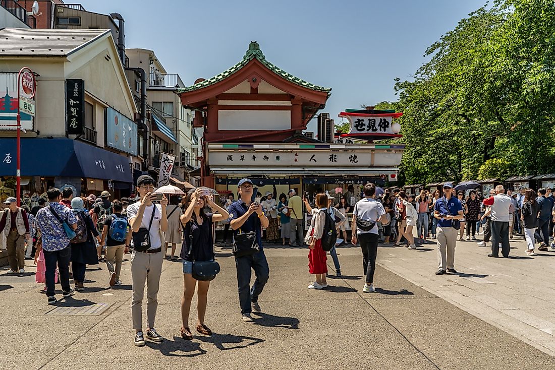 Tourists explore Tokyo, Japan. Editorial credit: Page Light Studios / Shutterstock.com.