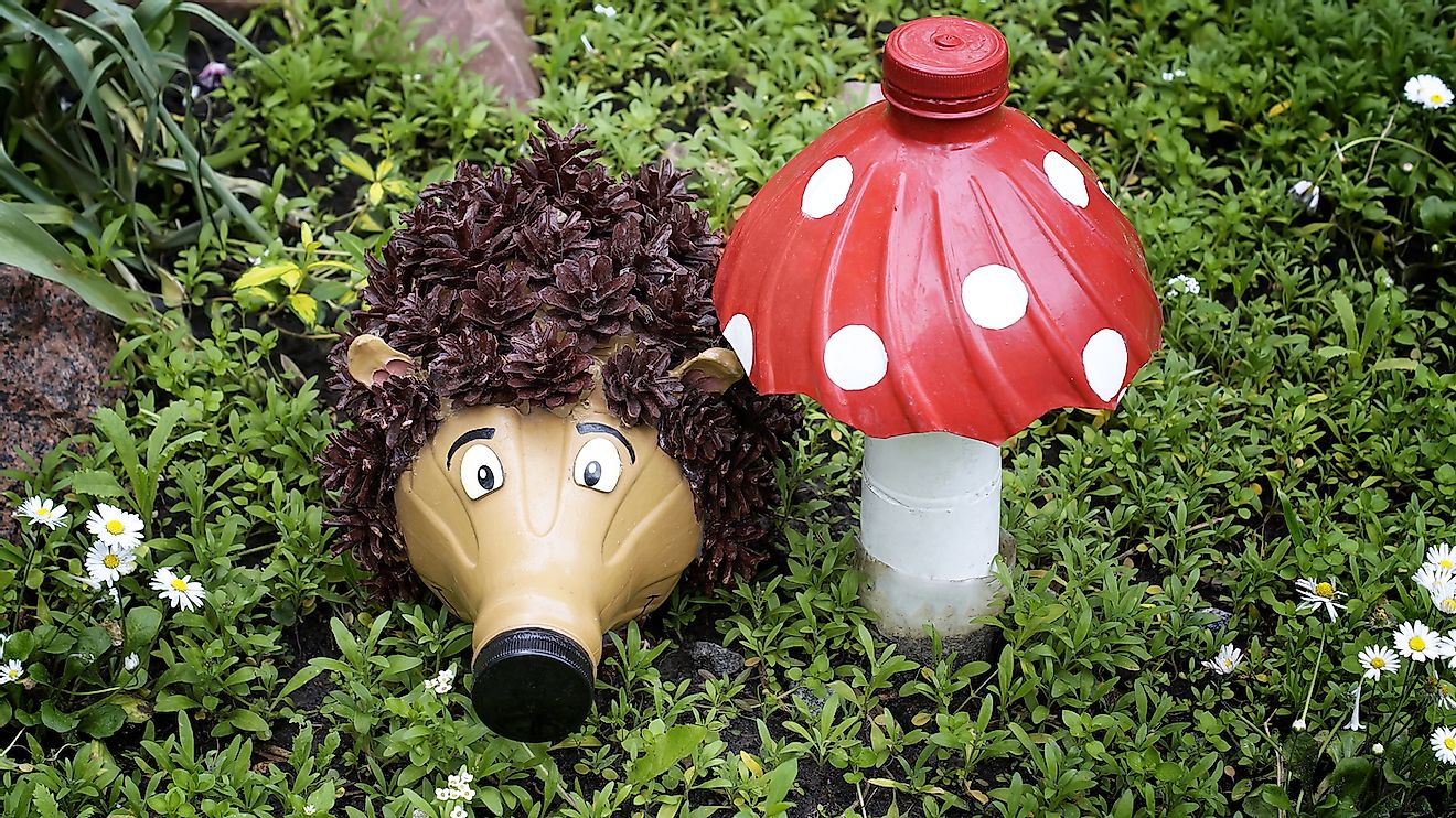 Recycling: a hedgehog and a mushroom made of plastic bottles in a garden. Image credit: Coltty/Shutterstock.com
