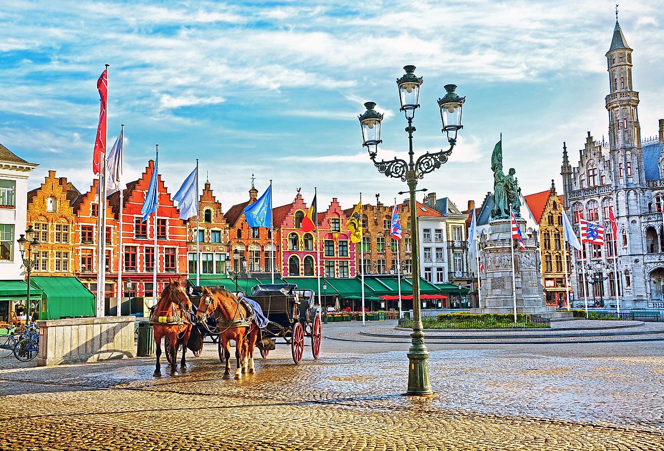 Horse carriages on Grote Markt square in medieval city Brugge, Belgium.