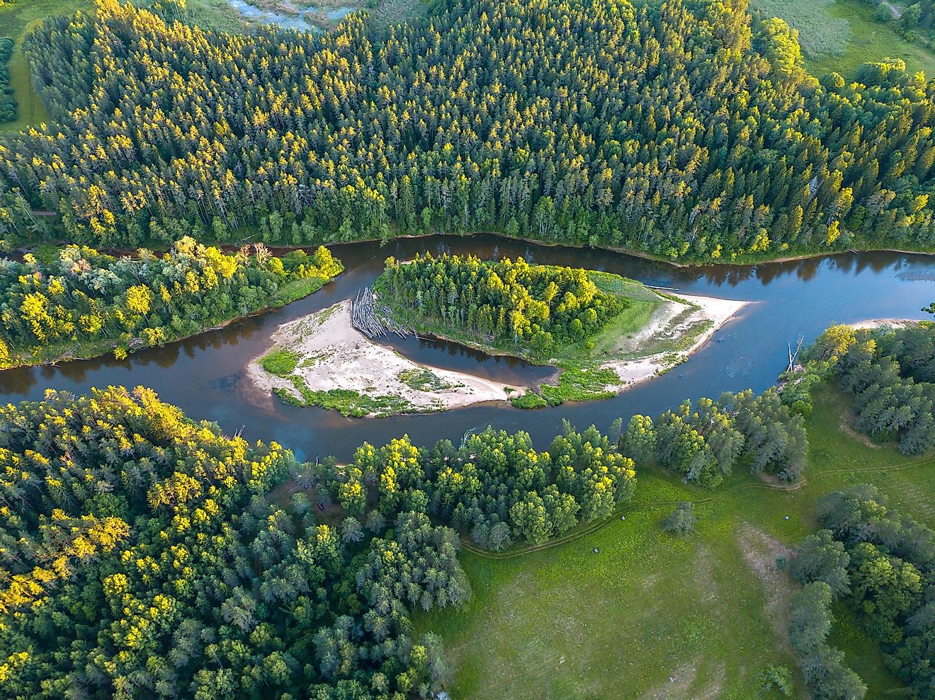 The scenic landscape of the Gauja River and surrounding forests in Latvia.