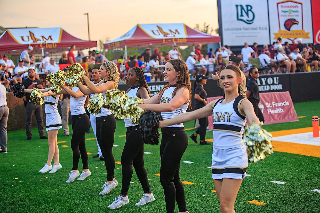 Army West Point Football faces off against the University of Louisiana at Monroe Warhawks at Malone Stadium in Monroe, Louisiana, with players on the field and fans filling the stands.