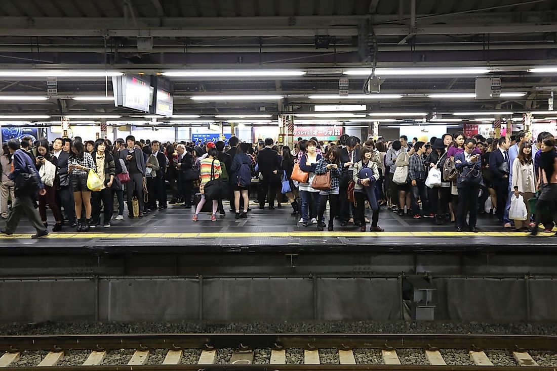 Passengers wait at Shinjuku Station, the busiest train station in the world. Editorial credit: charnsitr / Shutterstock.com.