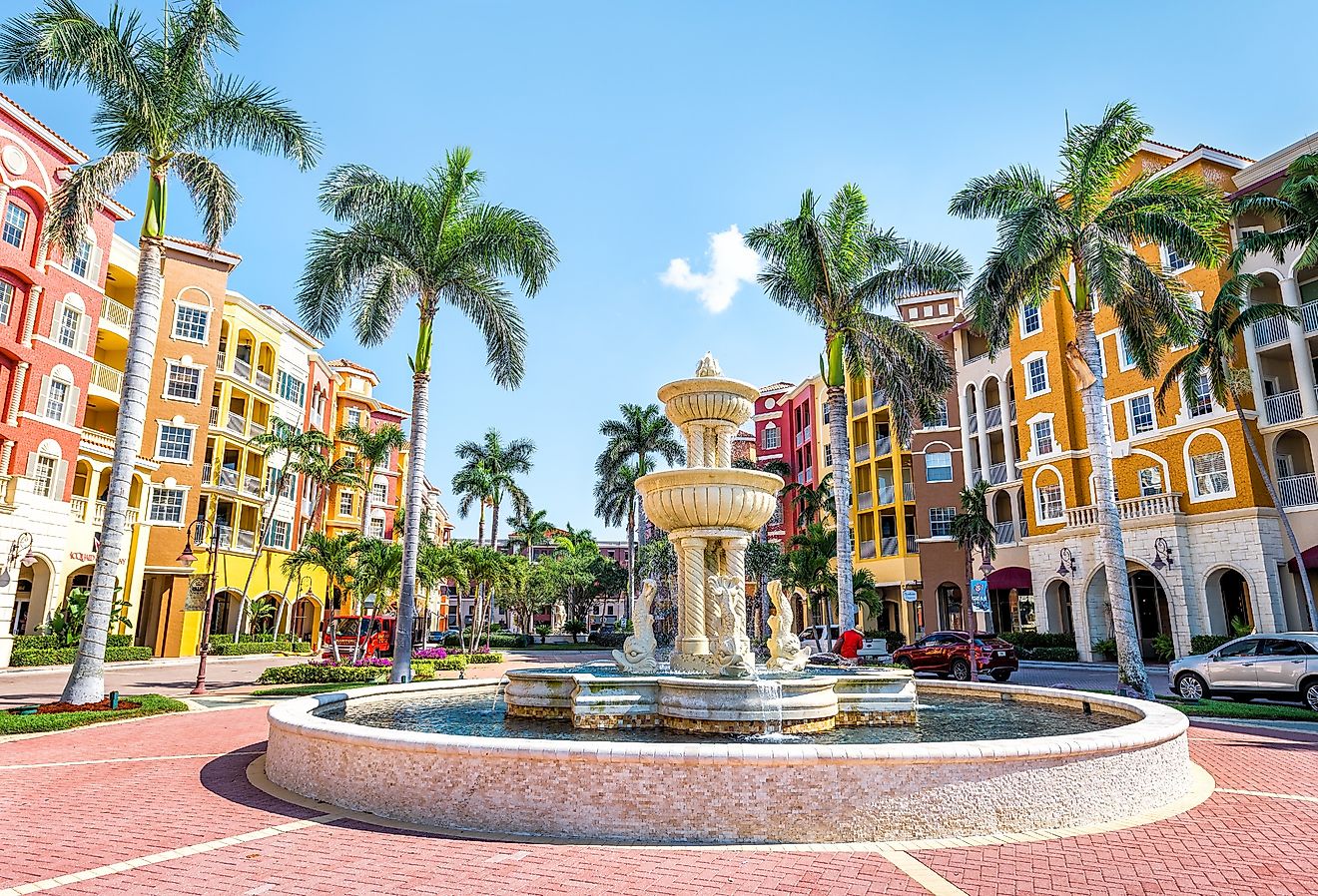 Colorful bayfront condos, with fountain, and palm trees in Naples, Florida. Image credit Andriy Blokhin via Shutterstock