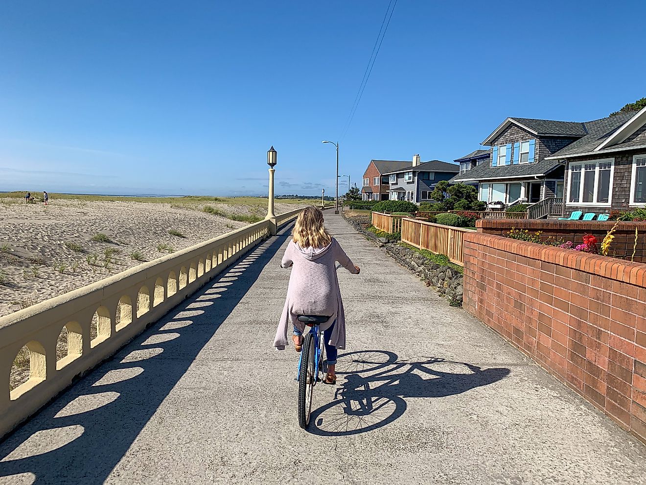 Woman biking on the Promenade in Seaside, Oregon.