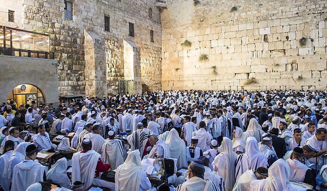 Jewish men praying at the Wailing Wall in Jerusalem.  Editorial credit: Kobby Dagan / Shutterstock.com