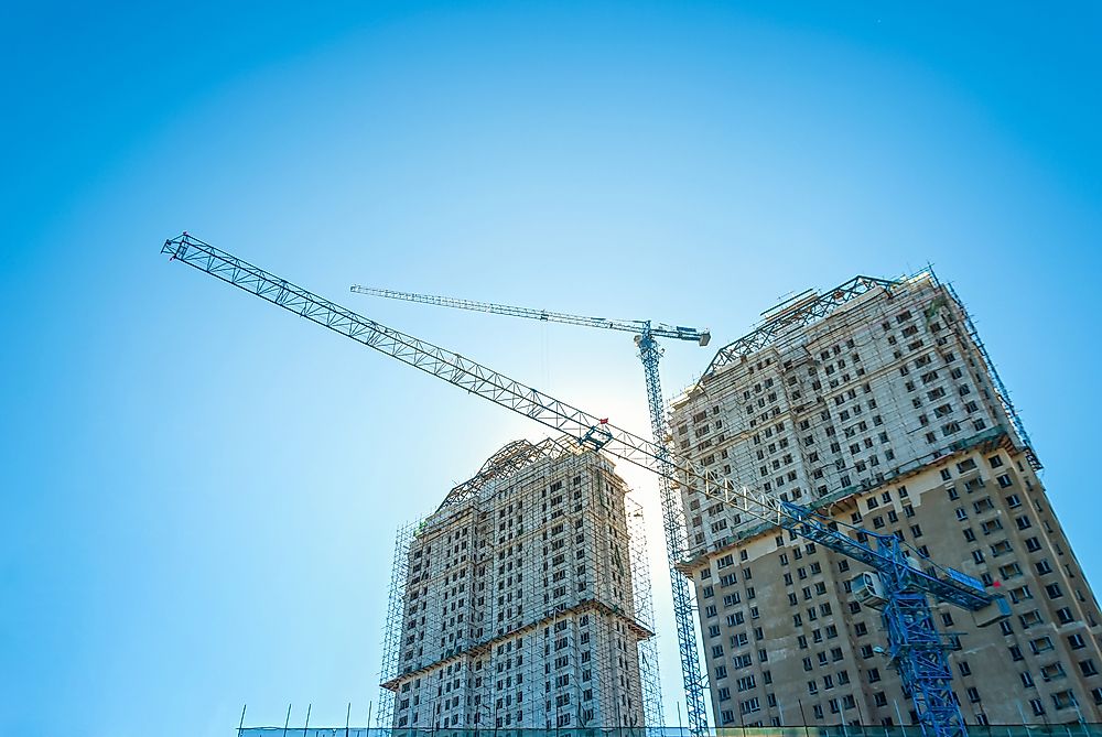 A construction crane in works on residential apartments in a Chinese city. 