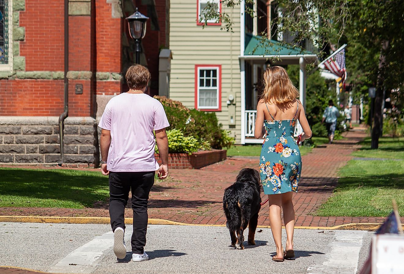 Couple is walking in the historic district of Chestertown, Maryland with their dog.