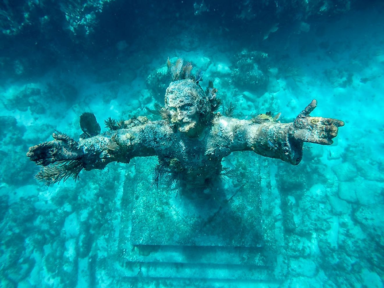 A statue of Jesus Christ that is placed underwater and is more than 8 feet tall.