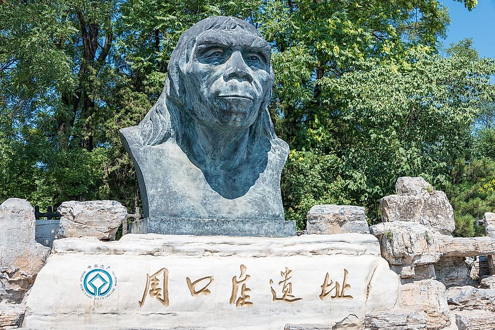 Peking Man statue at the Zhoukoudian cave system site in Beijing, China. Editorial credit: beibaoke / Shutterstock.com