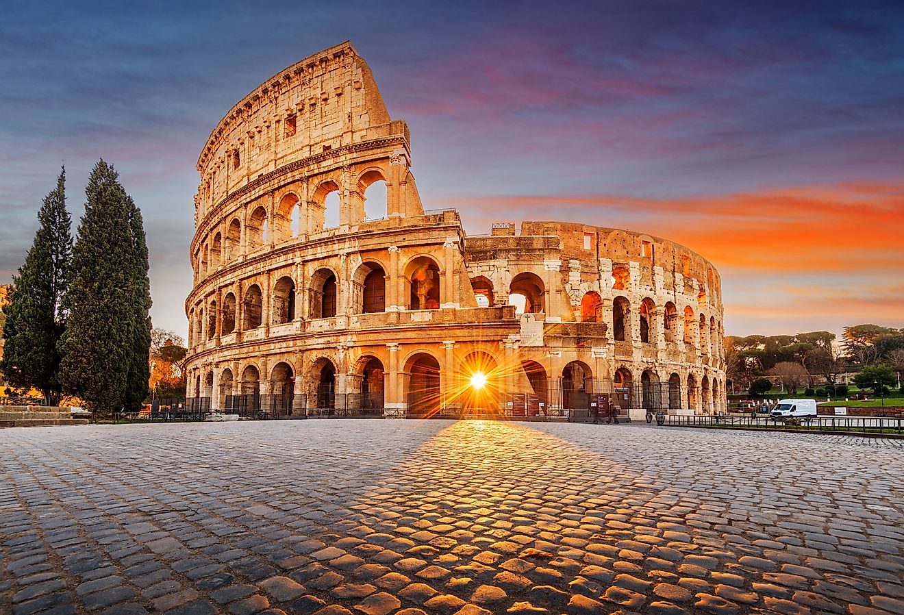 Rome, Italy at the Colosseum Amphitheater with the sunrise through the entranceway.