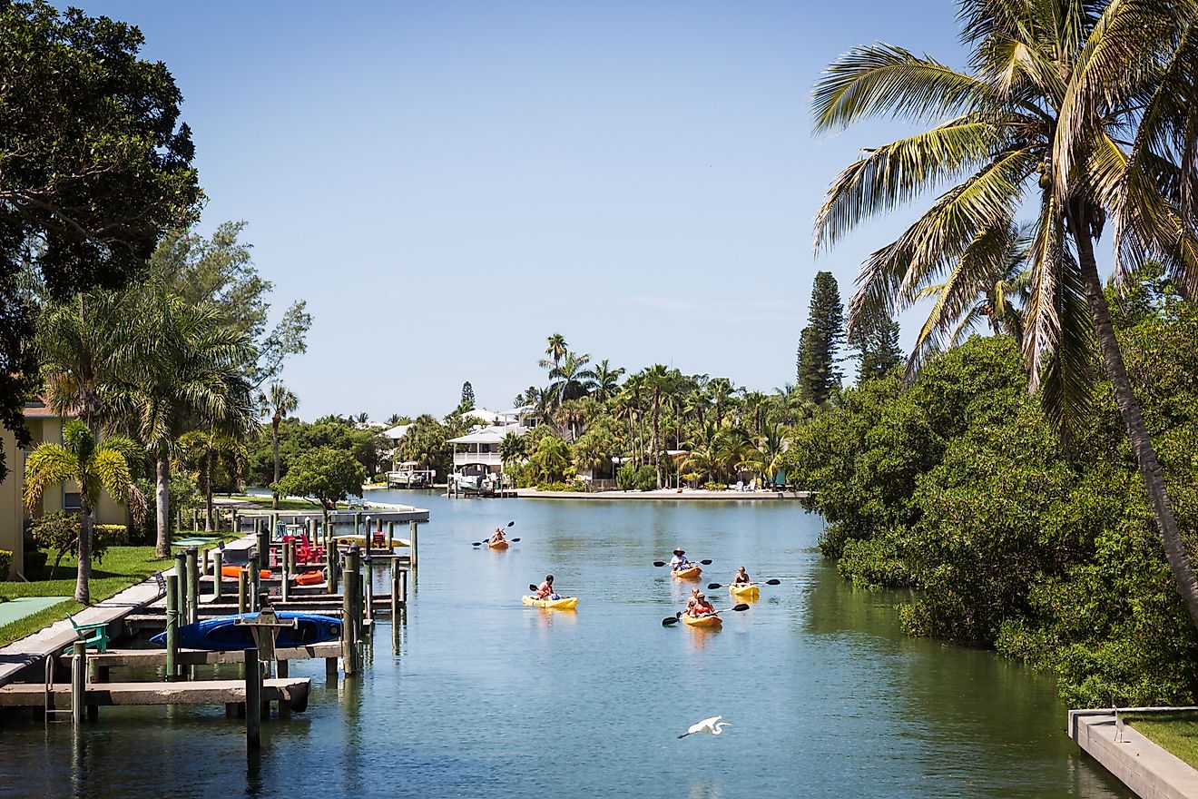  Kayakers floating in a canal on Anna Maria Island, Florida.