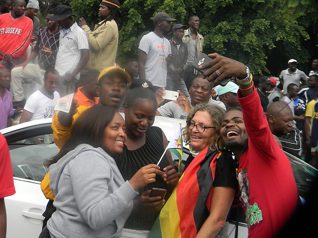 Zimbabweans celebrating the successful removal of President Robert Mugabe. Editorial credit: CECIL BO DZWOWA / Shutterstock.com