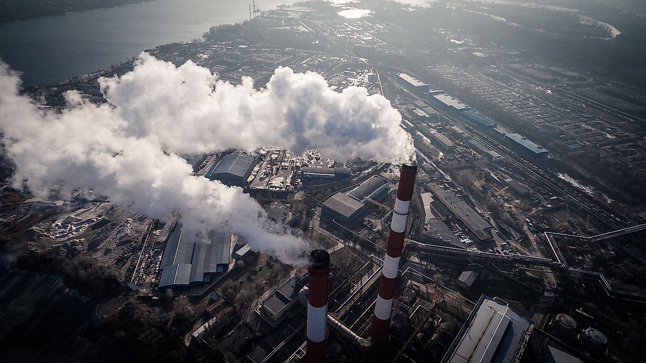 Air pollution caused by smoke coming out of two factory chimneys in the industrial zone of Kiev, Ukraine. Image credit: LALS STOCK/Shutterstock.com