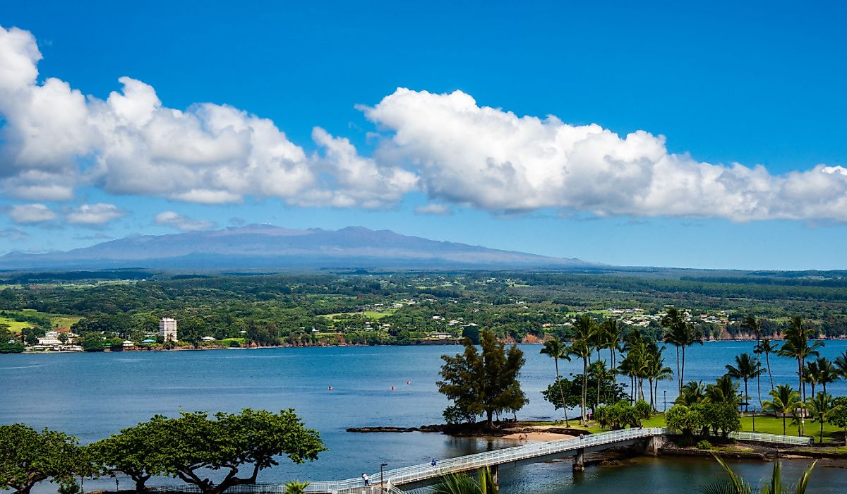 A view of Hilo, Hawaii and Mauna Kea on a clear day such that you can see the telescopes on the mountain peak.