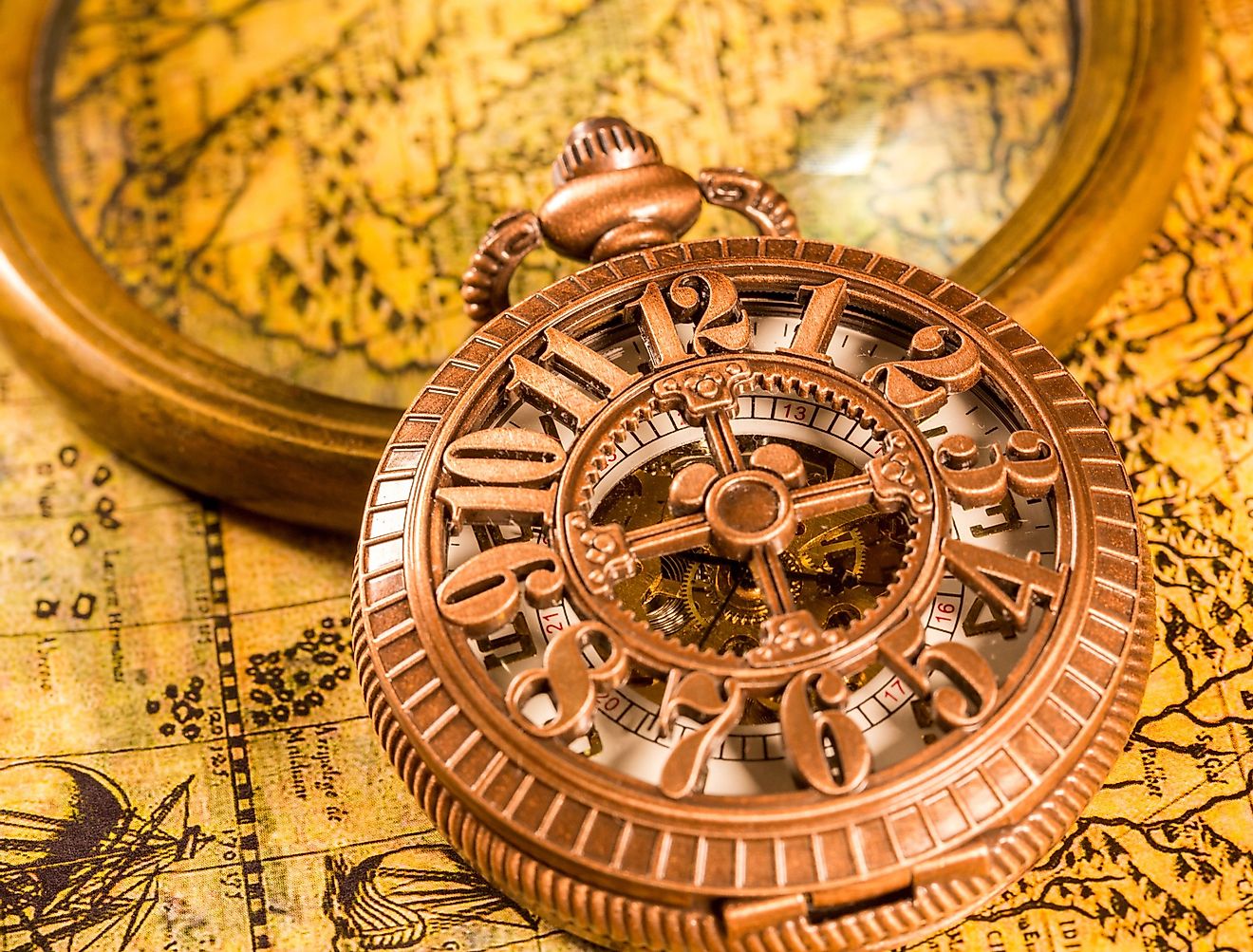 Vintage magnifying glass and pocket watch. Map of the Ancient World. Image credit RUl8let via shutterstock