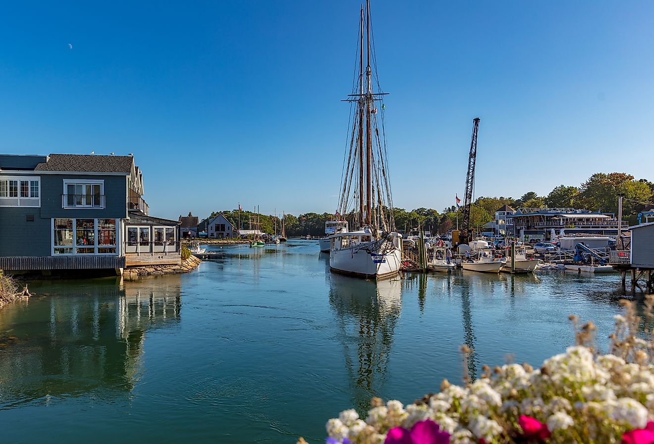Boats and homes along the water with flowers blooming in Kennebunkport, Maine.