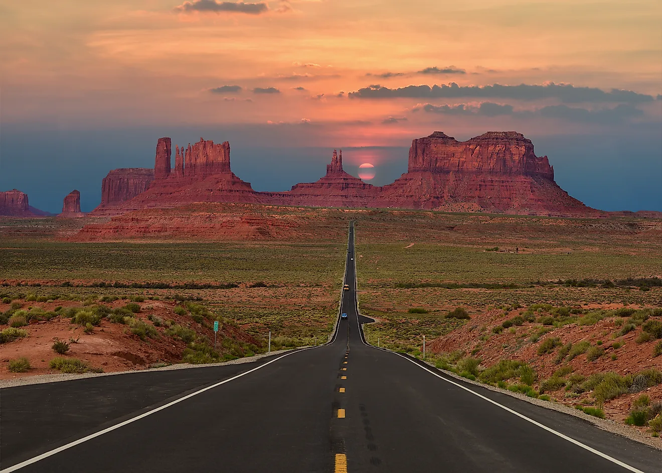 A highway running toward the buttes of Monument Valley near the Arizona-Utah line.