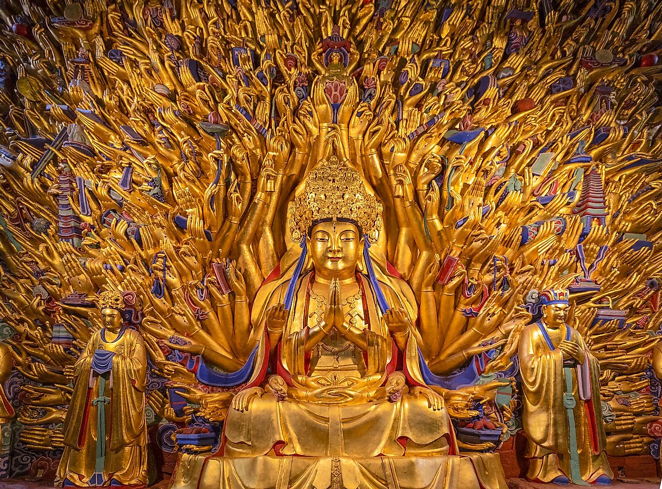 Golden sculpture of Avalokiteshvara Buddha or Guanyin with thousand hands at Dazu Rock Carvings at Mount Baoding or Baodingshan in Dazu, Chongqing, China. Image credit: NG-Spacetime/Shutterstock.com
