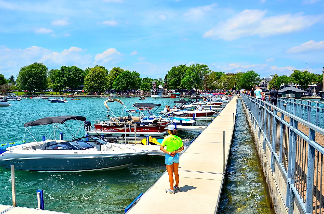 Pier and luxury boats docked in the Skaneateles Lake in Skaneateles, New York. Image credit: PQK / Shutterstock.com.