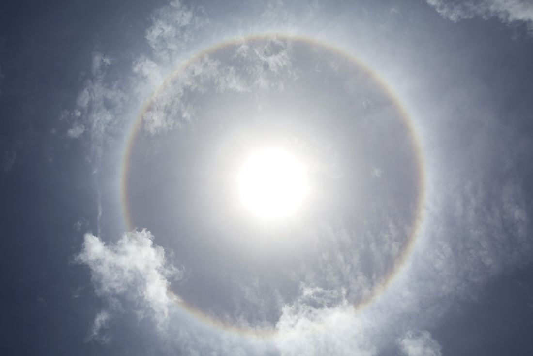 This phenomenon seen in the sky is known as an "ice crystal halo". False sunrises can result from ice crystal halos.