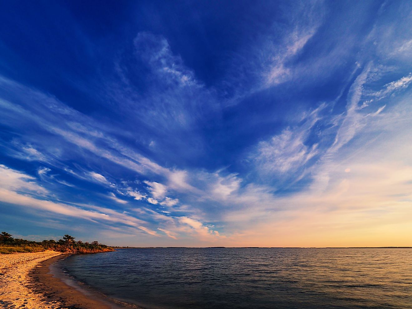 As twilight begins a dramatic sky unfolds before an empty beach at Rehoboth Bay, Delaware. 