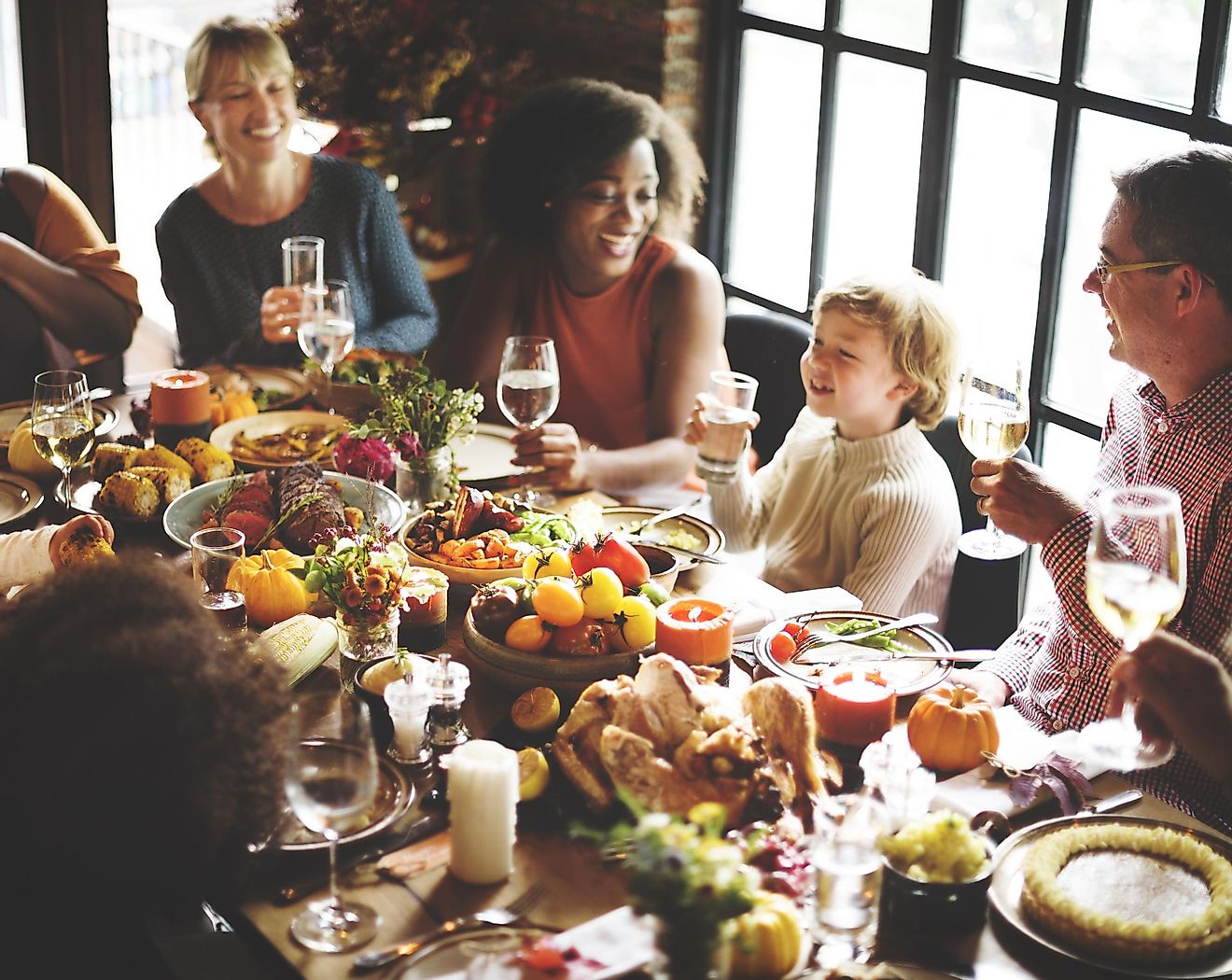 A modern-day American family celebrating Thanksgiving with a sumptuous feast. Image credit: Rawpixel.com/Shutterstock.com