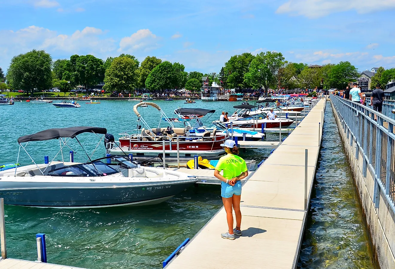 Pier and luxury boats docked in the Skaneateles Lake, Skaneateles, New York. Image credit PQK via Shutterstock