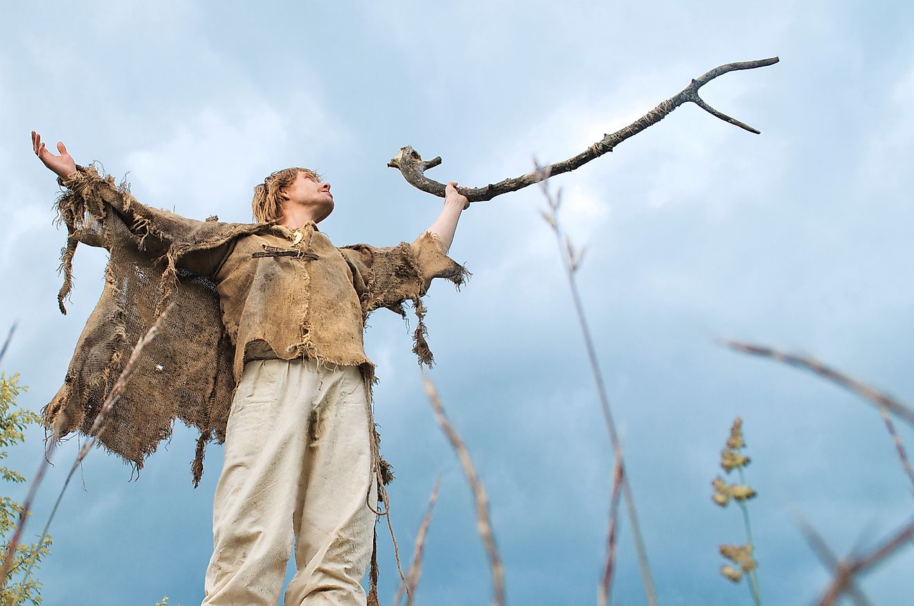 A druid man performing a ritual to invite rain.