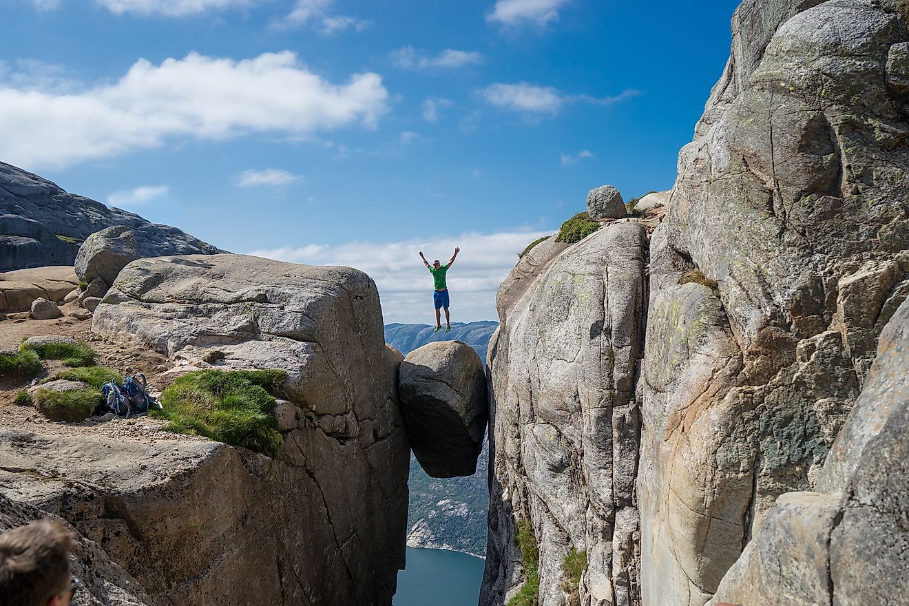 Man jumping over Kjeragbolten in Norway. Image credit:Viktor Hladchenko/Shutterstock.com