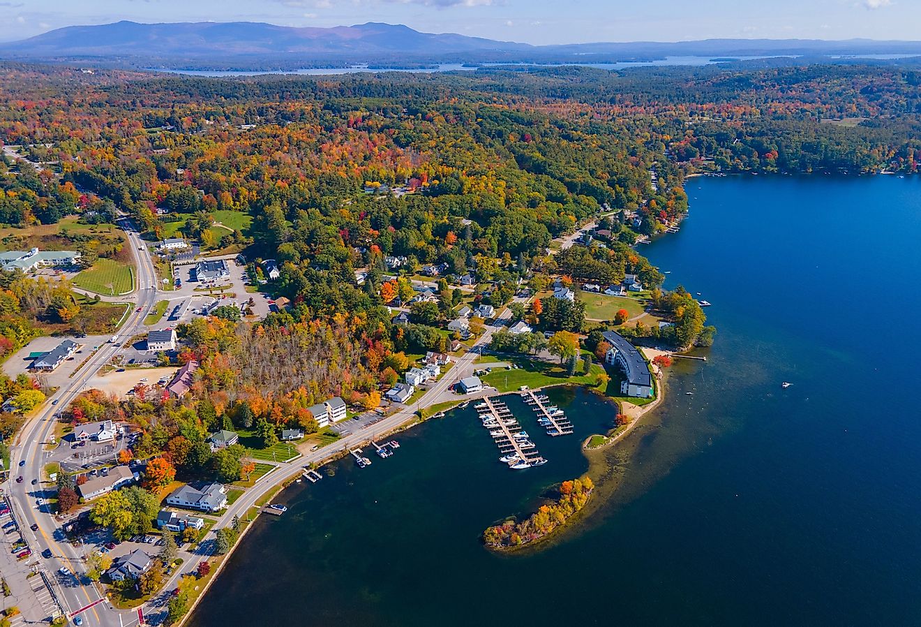 Waterfront of Meredith Bay in Lake Winnipesaukee at Meredith town center aerial view with fall foliage, New Hampshire