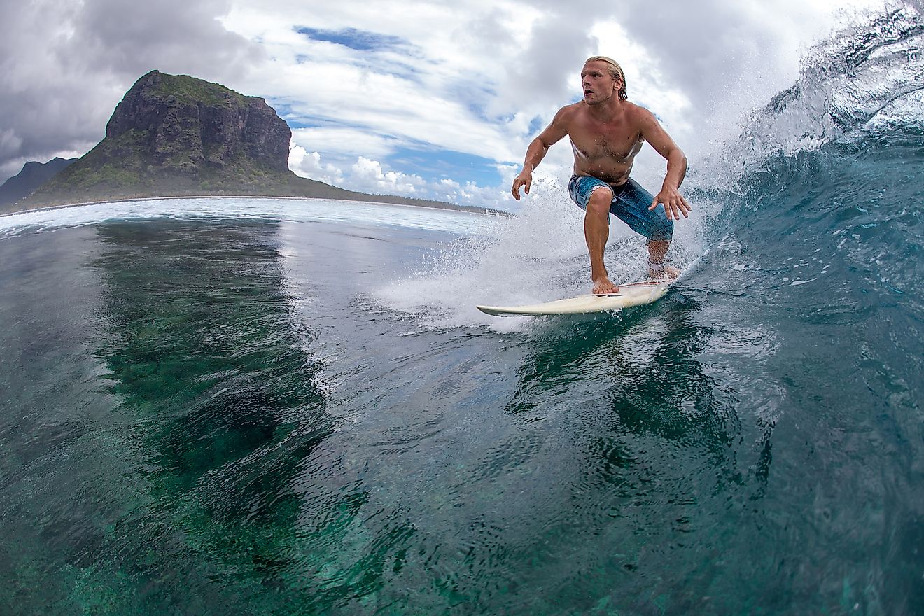 Surfing is a popular water sports in the Indian Ocean bordering Mauritius. Image credit: ohrim/Shutterstock.com