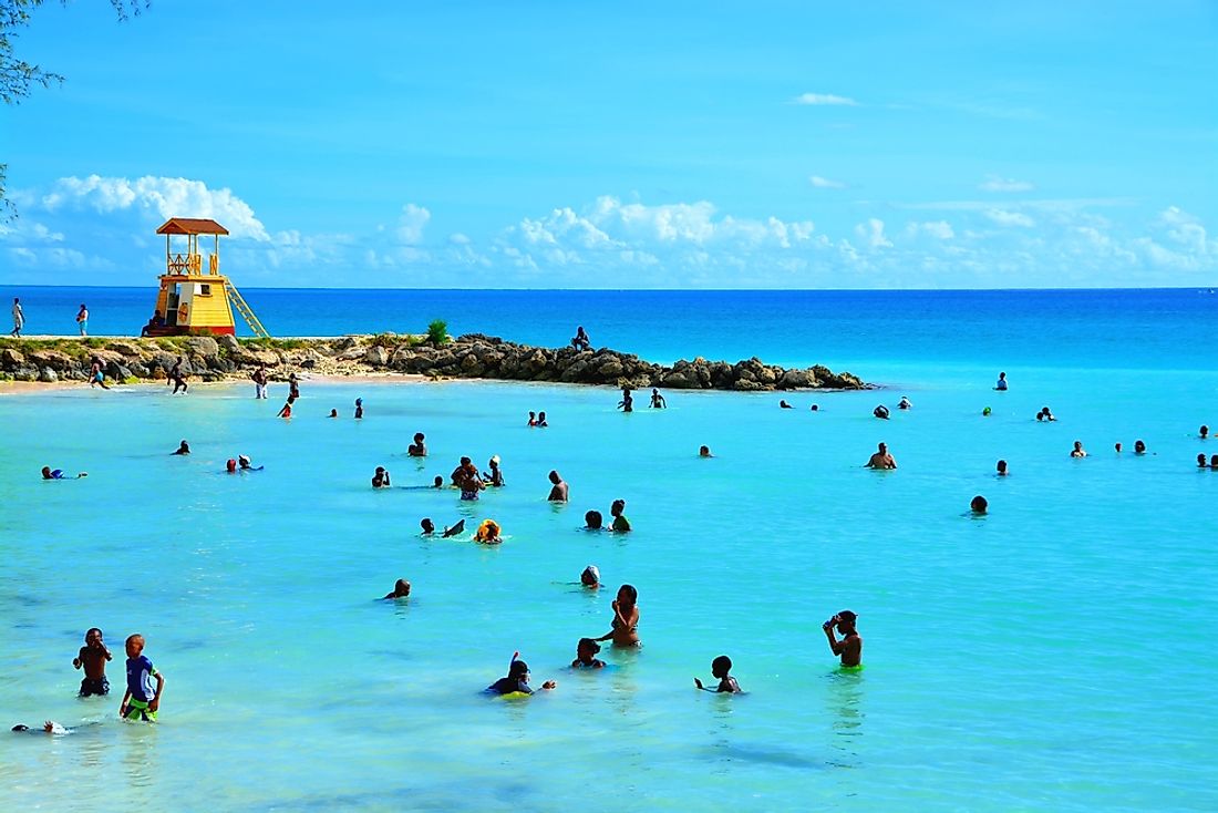 People in the ocean in Barbados. Editorial credit: Styve Reineck / Shutterstock.com. 