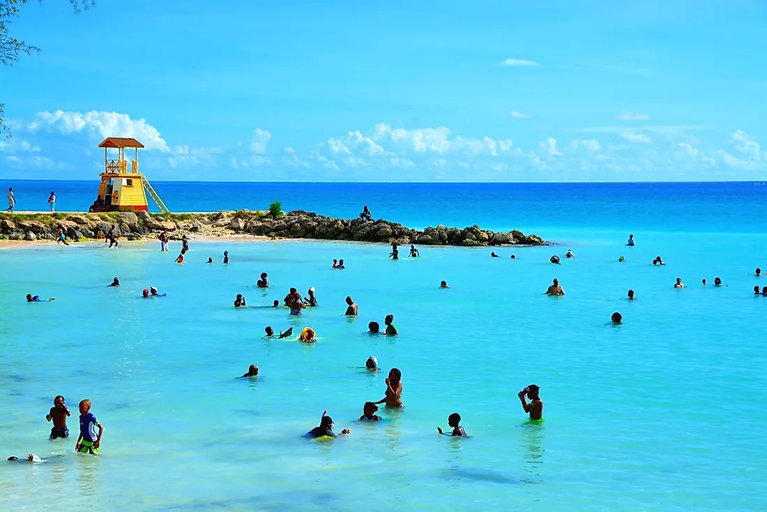 People in the ocean in Barbados. Editorial credit: Styve Reineck / Shutterstock.com. 