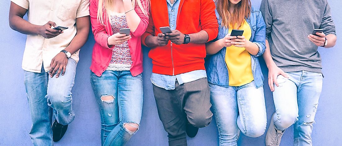 Young people busy with their cell phones at a party.