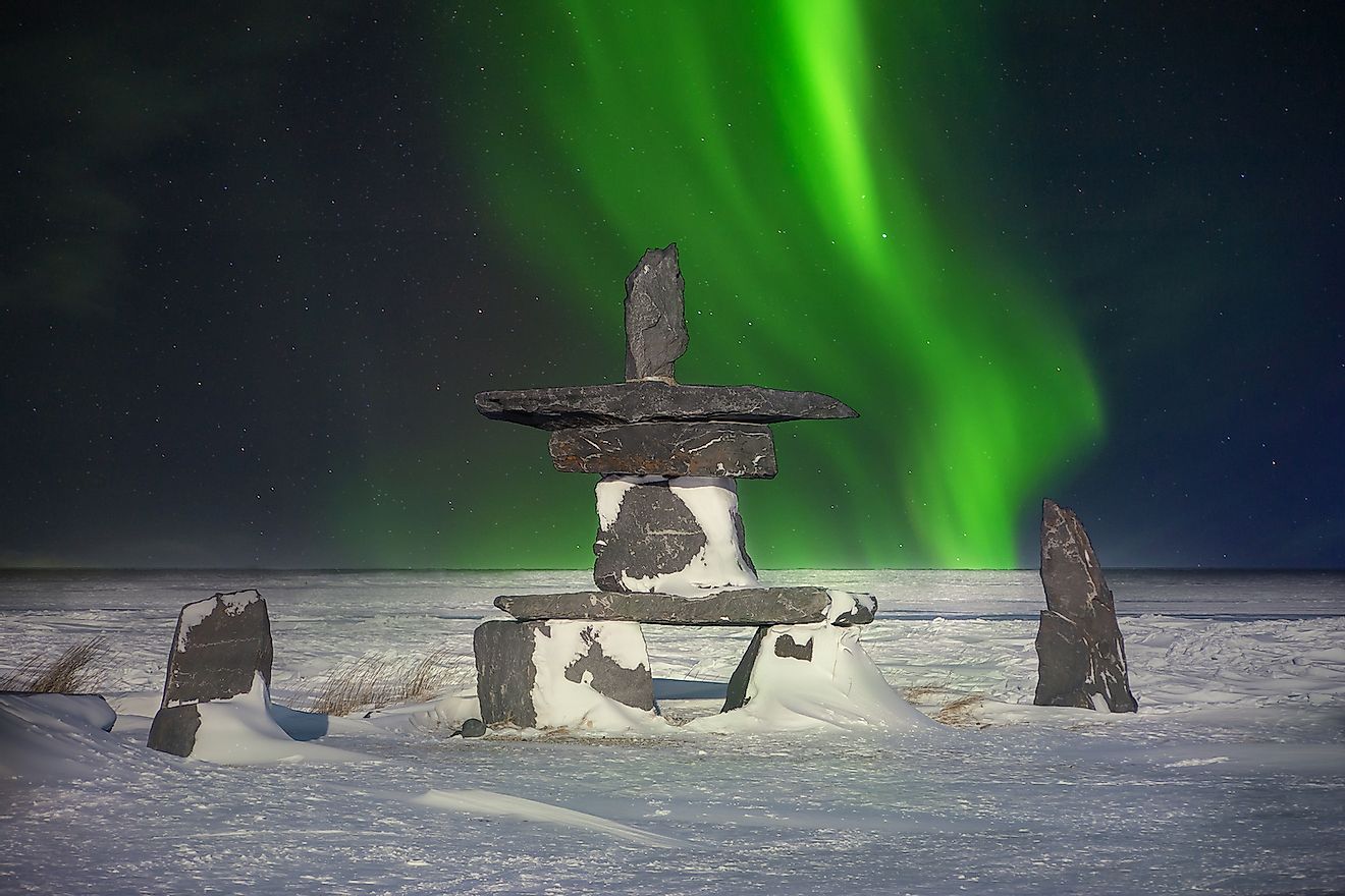 A traditional stone inukshuk, an Inuit cultural symbol used as a landmark to guide travelers in the far north, showing they are on the right path. Image credit: CherylRamalho/Shutterstock.com