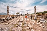 Tourist walking down an Ancient Roman road.