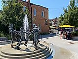 The sculpture fountain of Creemore’s Village Green courtyard flows into the sidewalk patio of the Bank Café. Photo Credit: Andrew Douglas