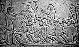 Kushite prisoners of war watched over by Egyptians, waiting to be deported into Egypt. 
