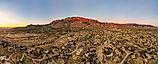Sandia mountains in Albuquerque, New Mexico at sunset, glowing pink.