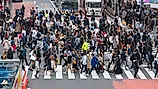 Shibuya crossing with many pedestrians and vehicles crossing the junction in Tokyo, Japan. Editorial credit: Cat Box / Shutterstock.com